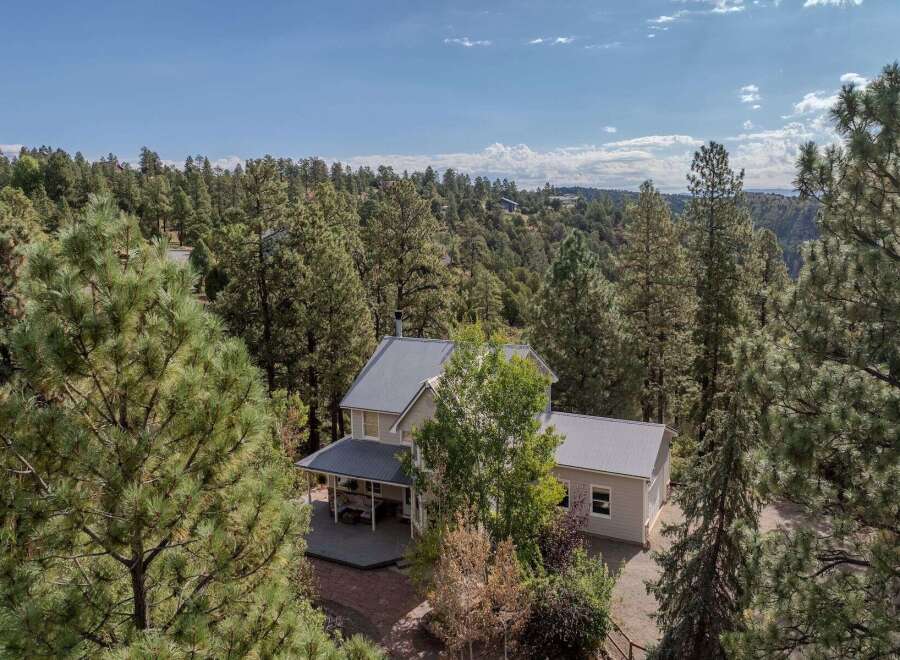 Nestled amidst a lush forest, this stunning property offers a serene escape.