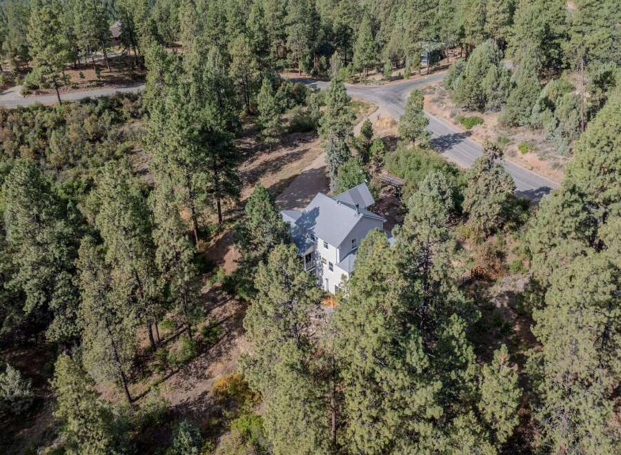 Nestled amidst a lush forest, this stunning property offers a serene escape.