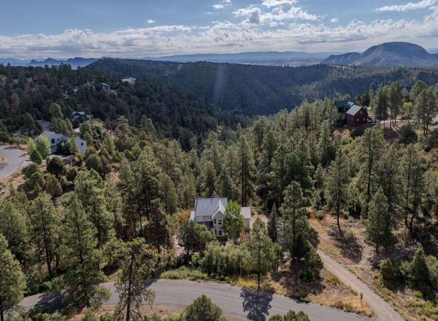 Nestled in a serene, wooded landscape, this stunning property offers unparalleled privacy and breathtaking views.