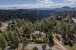 Nestled in a serene, wooded landscape, this stunning property offers unparalleled privacy and breathtaking views.