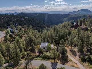 Nestled in a serene, wooded landscape, this stunning property offers unparalleled privacy and breathtaking views.