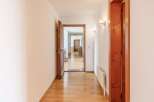 Step into this inviting hallway, showcasing beautiful hardwood floors and a warm, welcoming atmosphere.