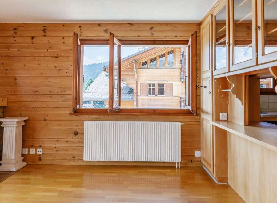 This charming property boasts a warm and inviting interior with beautiful wooden paneling throughout.