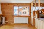 This charming property boasts a warm and inviting interior with beautiful wooden paneling throughout.