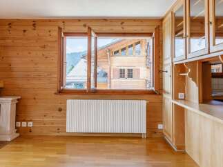 This charming property boasts a warm and inviting interior with beautiful wooden paneling throughout.
