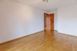 This inviting room features beautiful hardwood floors and crisp white walls, creating a bright and airy atmosphere.