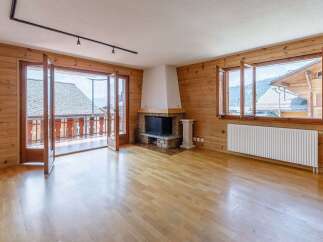 This stunning property boasts a warm and inviting interior with beautiful wooden accents throughout.