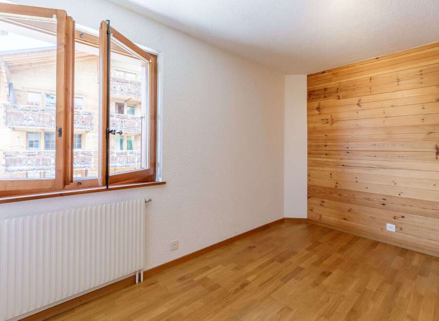 This inviting room features a stunning wooden accent wall that adds warmth and character.