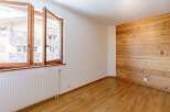 This inviting room features a stunning wooden accent wall that adds warmth and character.