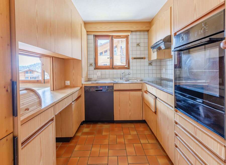 This charming kitchen features warm wooden cabinetry and a functional layout.