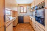 This charming kitchen features warm wooden cabinetry and a functional layout.