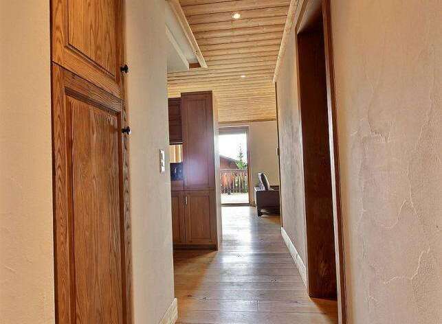 Step into this inviting hallway, showcasing beautiful wooden floors and a warm, natural aesthetic.