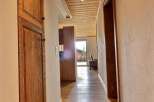 Step into this inviting hallway, showcasing beautiful wooden floors and a warm, natural aesthetic.