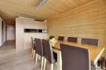 This stunning dining area features a beautiful wooden table and comfortable leather chairs, perfect for hosting gatherings.