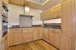 This stunning kitchen boasts custom cabinetry, offering ample storage and a warm, inviting atmosphere.