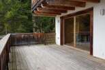 Enjoy the tranquility of this stunning property with a spacious wooden deck, perfect for outdoor relaxation.