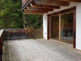 Enjoy the tranquility of this stunning property with a spacious wooden deck, perfect for outdoor relaxation.