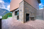 Discover modern luxury in this stunning property featuring a unique stone facade and a beautifully designed outdoor space.