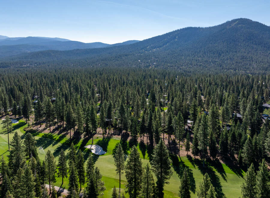 Experience the tranquility of this stunning golf course property, nestled amidst a lush forest.