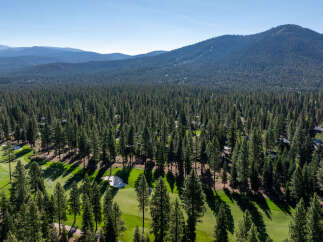 Experience the tranquility of this stunning golf course property, nestled amidst a lush forest.