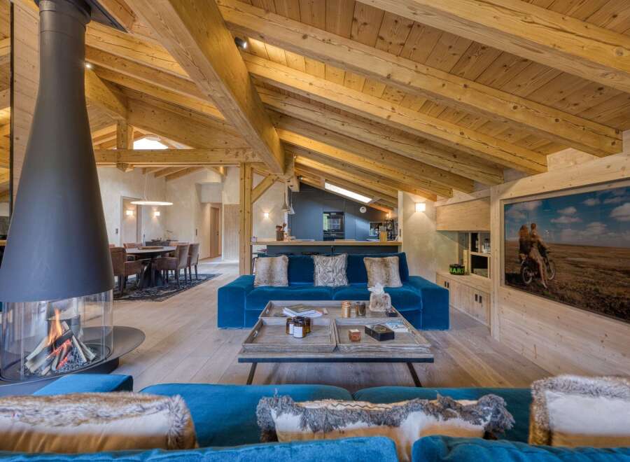 Experience luxury living in this stunning chalet, featuring a cozy fireplace and a spacious living area.