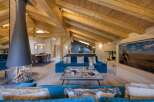 Experience luxury living in this stunning chalet, featuring a cozy fireplace and a spacious living area.