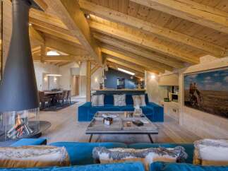 Experience luxury living in this stunning chalet, featuring a cozy fireplace and a spacious living area.