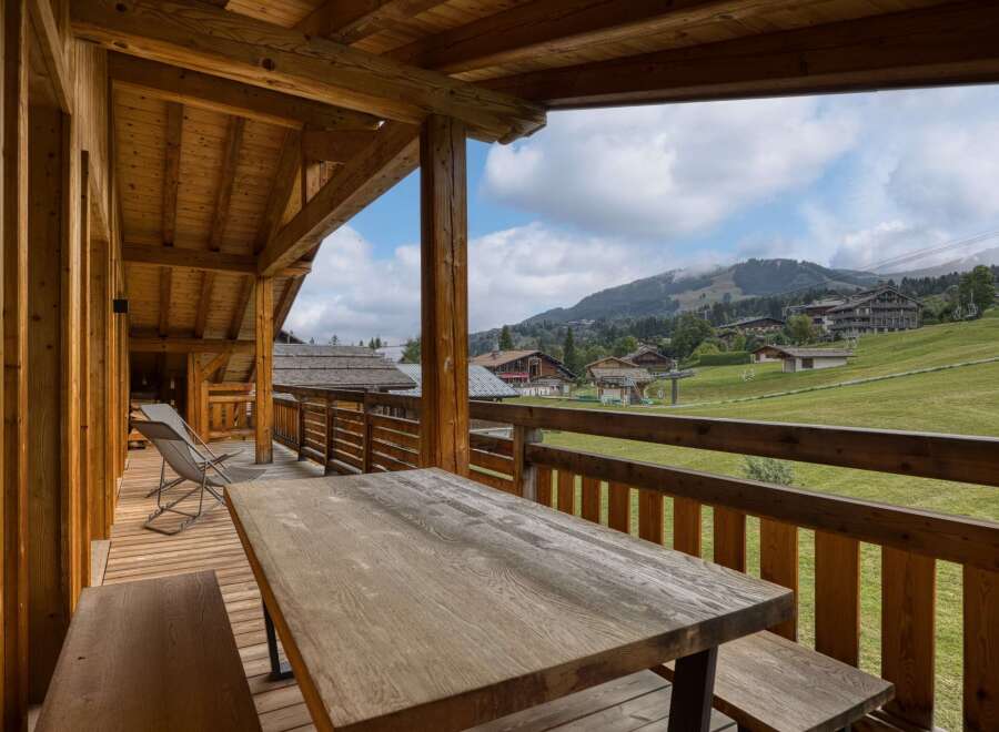 Enjoy breathtaking mountain views from this charming wooden balcony.