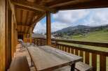 Enjoy breathtaking mountain views from this charming wooden balcony.