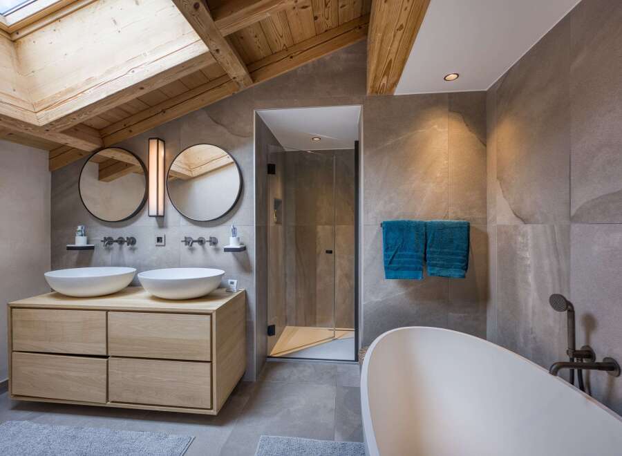 Experience luxury in this stunning bathroom, featuring a modern design with a touch of rustic charm.