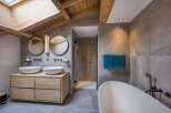Experience luxury in this stunning bathroom, featuring a modern design with a touch of rustic charm.