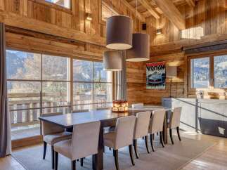 Experience the warmth of this stunning dining room, featuring exquisite wooden paneling and a captivating view.