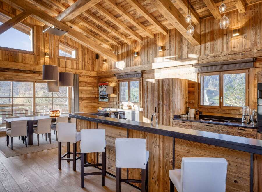 This stunning kitchen boasts a rustic charm with its wooden ceiling and walls, creating a warm and inviting atmosphere.