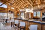 This stunning kitchen boasts a rustic charm with its wooden ceiling and walls, creating a warm and inviting atmosphere.