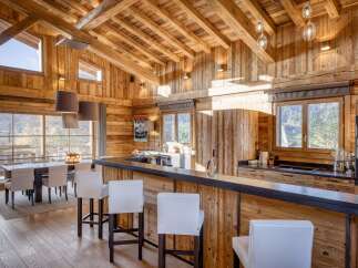 This stunning kitchen boasts a rustic charm with its wooden ceiling and walls, creating a warm and inviting atmosphere.