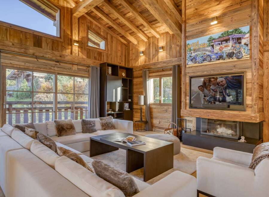 Experience the warmth of this stunning chalet-style living room, featuring exquisite wooden paneling throughout.