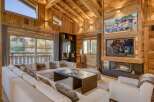 Experience the warmth of this stunning chalet-style living room, featuring exquisite wooden paneling throughout.