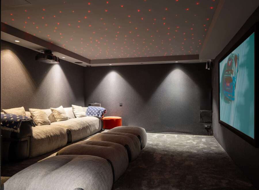 Step into luxury with this stunning home theater! Featuring a plush, oversized sofa and a unique, star-lit ceiling, this space is designed for ultimate relaxation and entertainment.