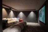 Step into luxury with this stunning home theater! Featuring a plush, oversized sofa and a unique, star-lit ceiling, this space is designed for ultimate relaxation and entertainment.