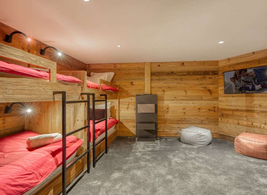 This cozy bedroom features custom-built bunk beds, perfect for accommodating guests or family members.