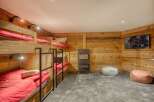 This cozy bedroom features custom-built bunk beds, perfect for accommodating guests or family members.