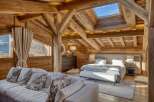 Experience the epitome of rustic luxury in this stunning chalet bedroom.