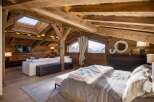 Experience the epitome of rustic luxury in this stunning chalet-style bedroom.