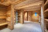 Step into a luxurious ski storage room, designed with natural wood paneling and a modern ski boot drying system.