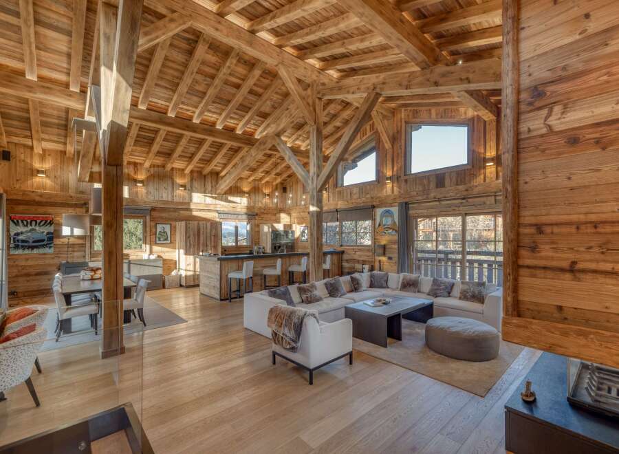 Experience luxury living in this stunning chalet, showcasing exquisite wooden architecture and a spacious open-plan design.
