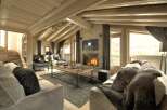 Experience luxury living in this stunning chalet, featuring a cozy fireplace and a stylish living area.