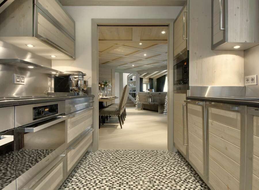 Step into a beautifully designed kitchen, showcasing modern appliances and elegant wooden cabinetry.