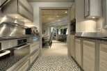 Step into a beautifully designed kitchen, showcasing modern appliances and elegant wooden cabinetry.