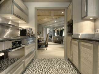 Step into a beautifully designed kitchen, showcasing modern appliances and elegant wooden cabinetry.