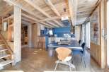 Experience rustic elegance in this stunning property, featuring a warm wooden interior and exposed beams.